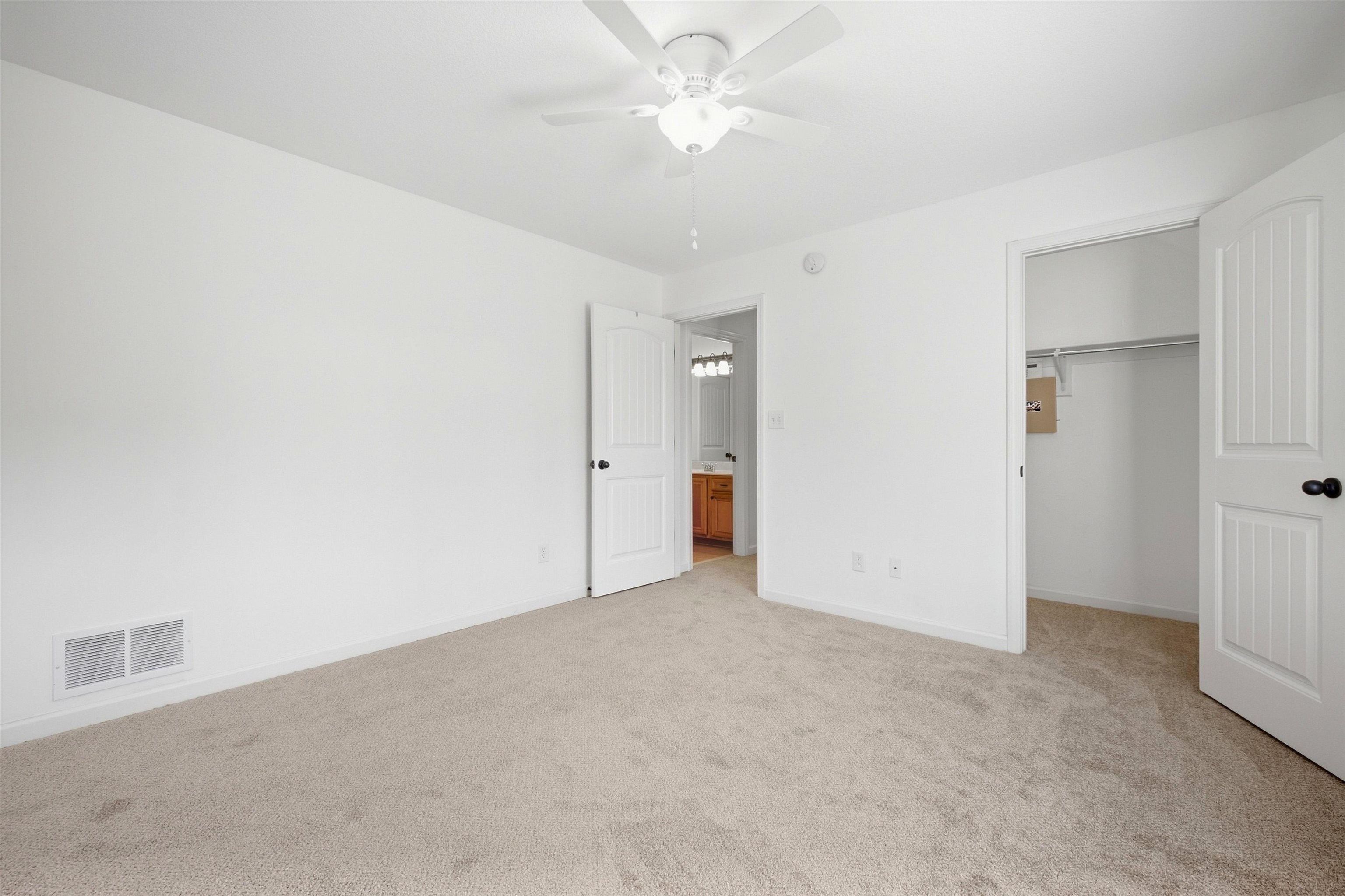 7920 Pips Ridge Lane Bartlett, TN 38133 - Photo 33 of 40 Neutral carpeted flooring, white walls, white ceiling fan with integrated lighting, and white paneled doors