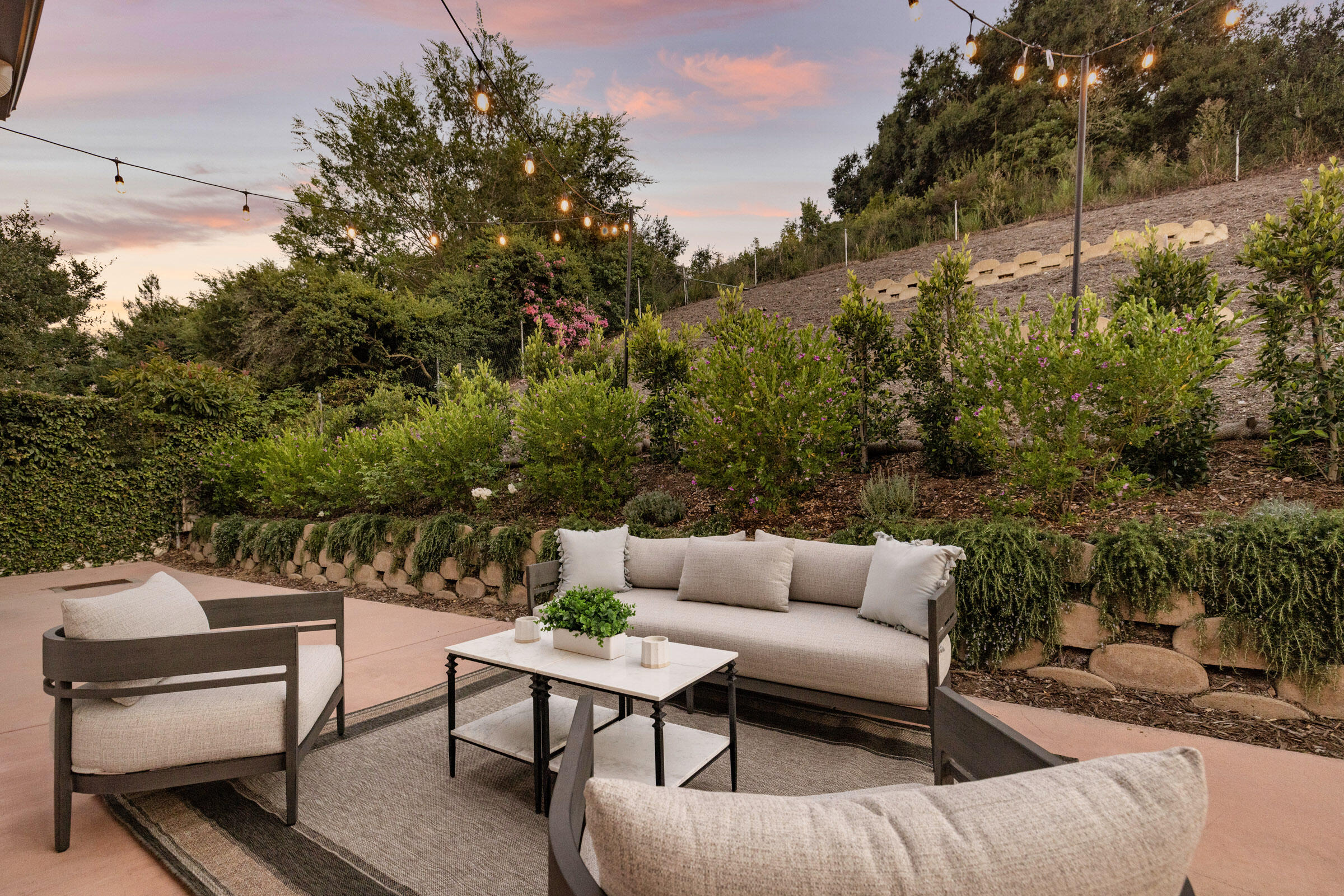 1215 Miracanon Lane Santa Barbara, CA 93109 - Photo 19 of 40 a view of a patio with couches and a potted plant on a table