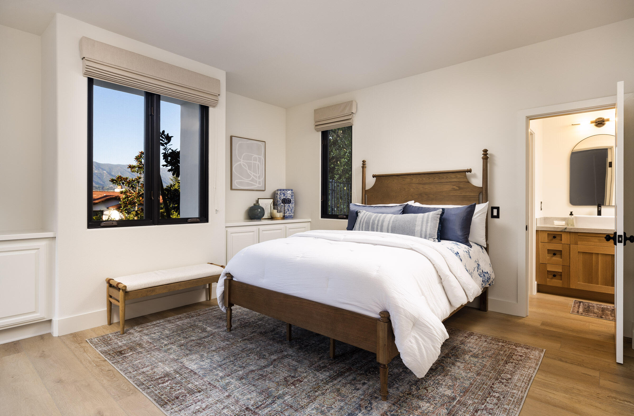 1215 Miracanon Lane Santa Barbara, CA 93109 - Photo 24 of 40 a bedroom with a bed and a flat tv screen on dresser