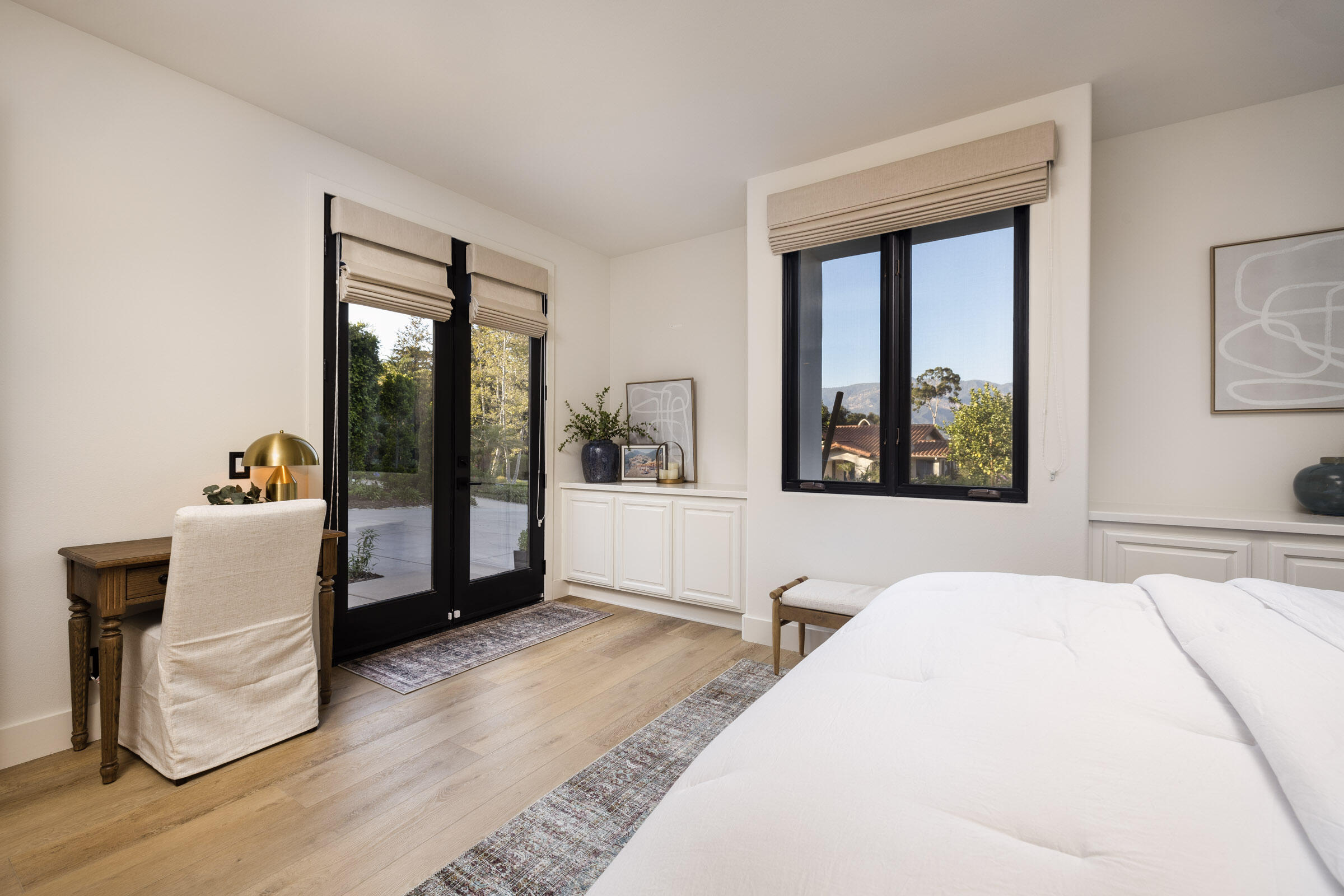 1215 Miracanon Lane Santa Barbara, CA 93109 - Photo 25 of 40 a bedroom with a large bed and a large window