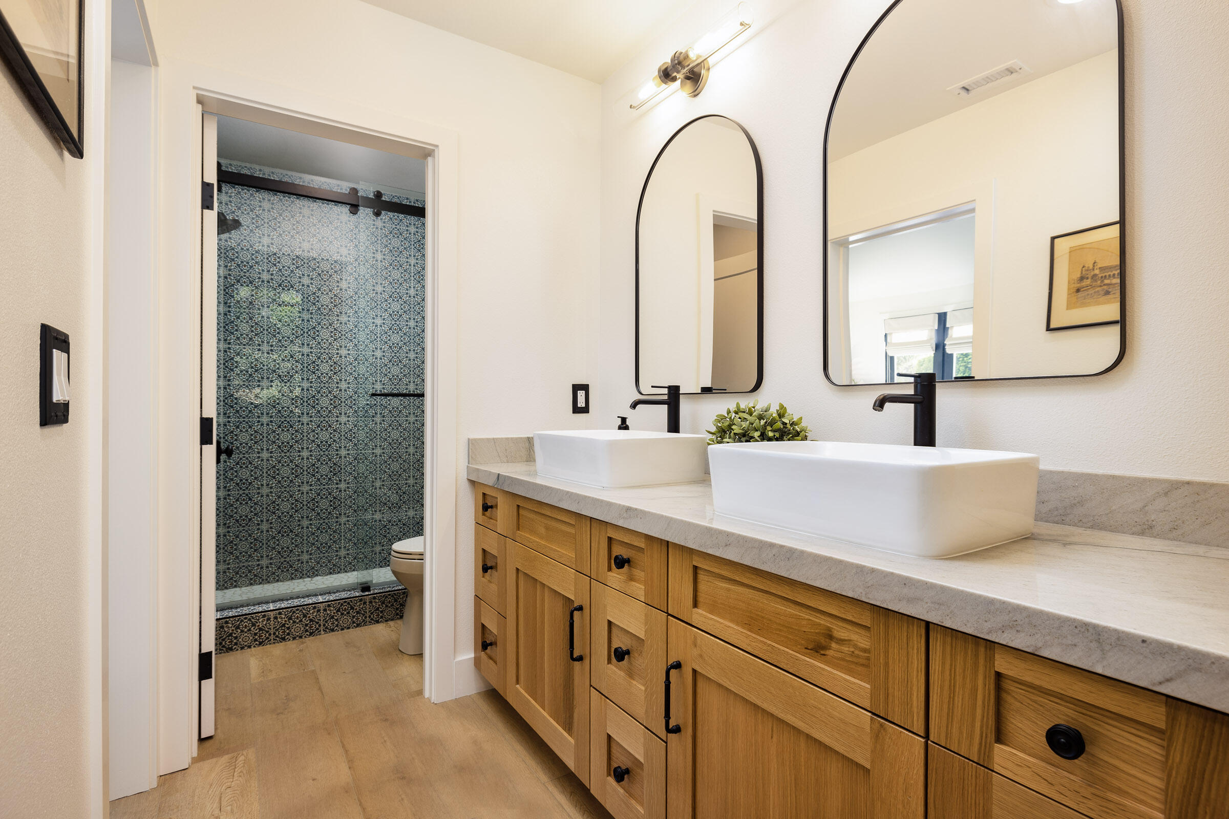 1215 Miracanon Lane Santa Barbara, CA 93109 - Photo 27 of 40 a bathroom with a double vanity sink and mirror