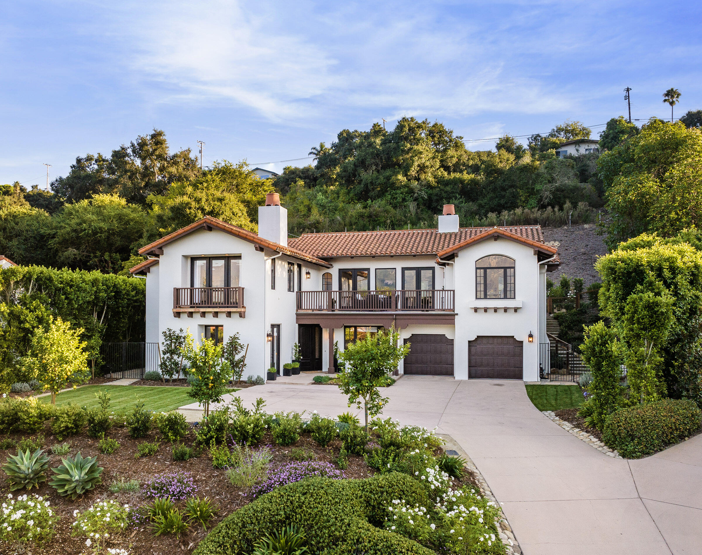 1215 Miracanon Lane Santa Barbara, CA 93109 - Photo 33 of 40 a front view of a house with a yard and potted plants