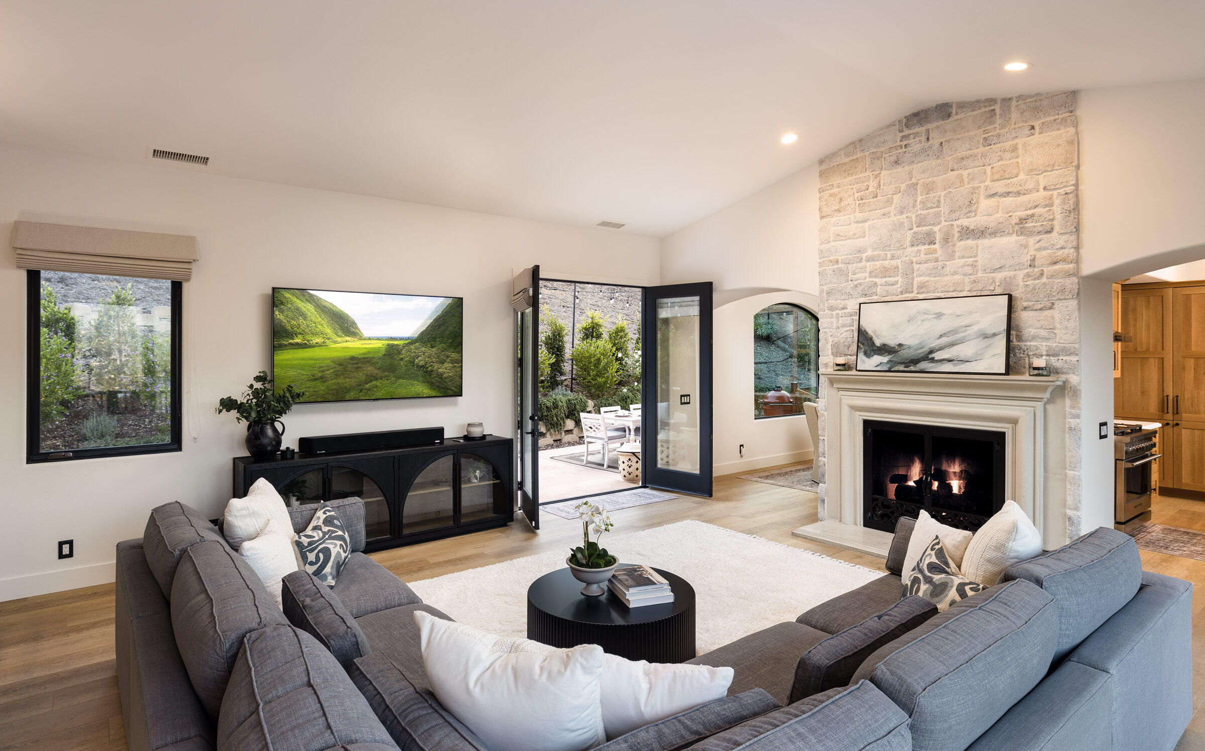 1215 Miracanon Lane Santa Barbara, CA 93109 - Photo 6 of 40 a living room with furniture a fireplace and a flat screen tv