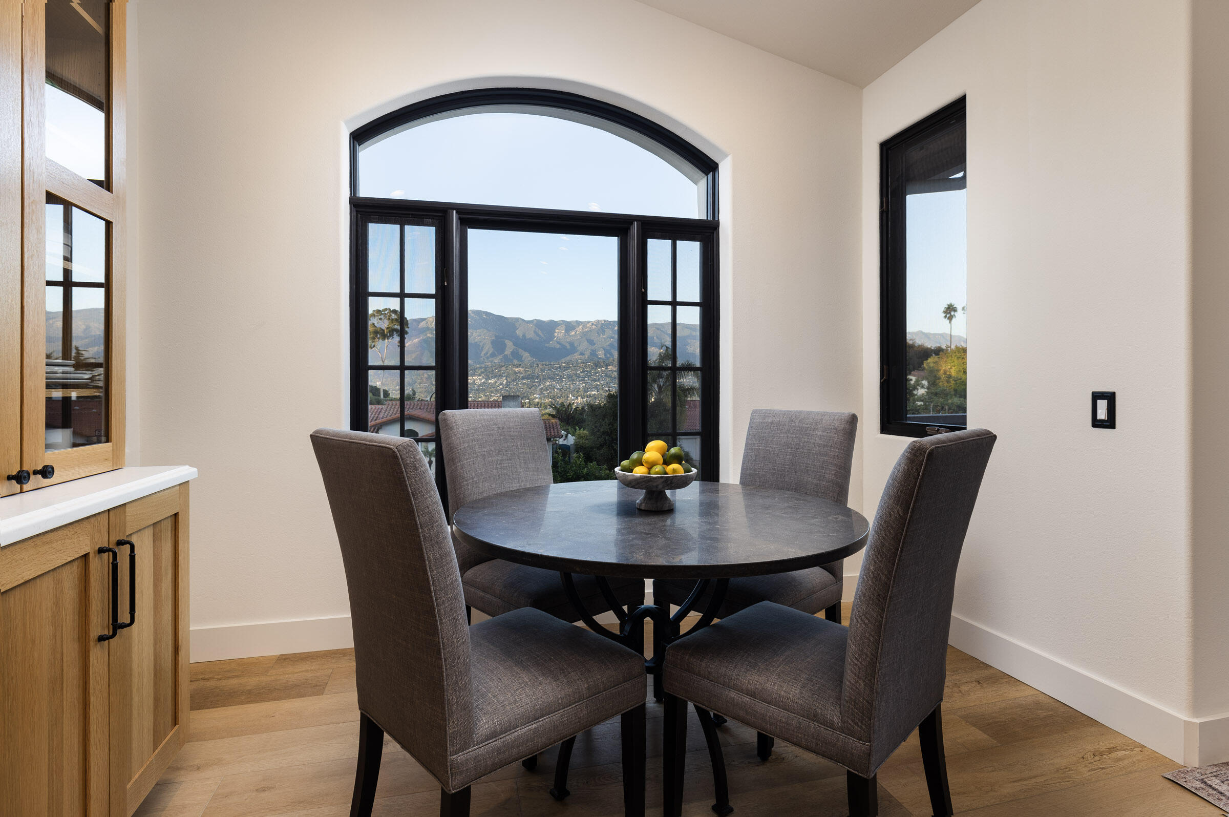 1215 Miracanon Lane Santa Barbara, CA 93109 - Photo 9 of 40 a view of a dining room with furniture window and wooden floor