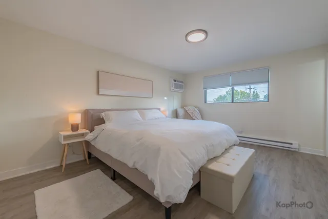 a bedroom with a bed and a night stand