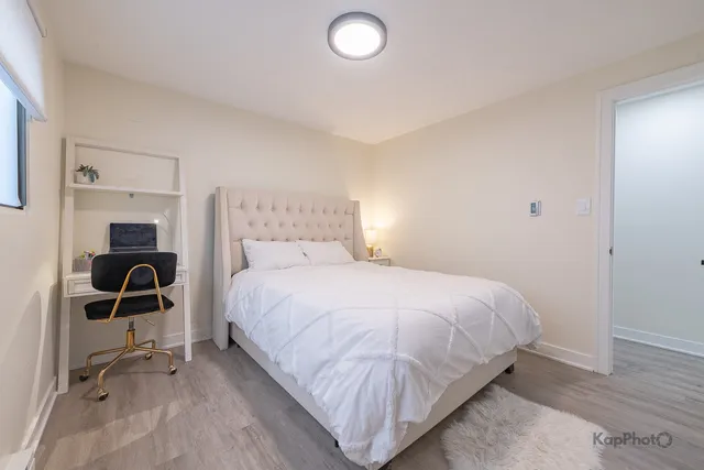 a bedroom with a bed and a chair