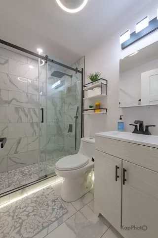 a bathroom with a shower toilet and sink