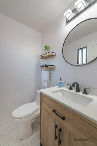 a bathroom with a sink a toilet and mirror