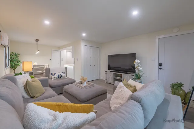a living room with furniture and a flat screen tv