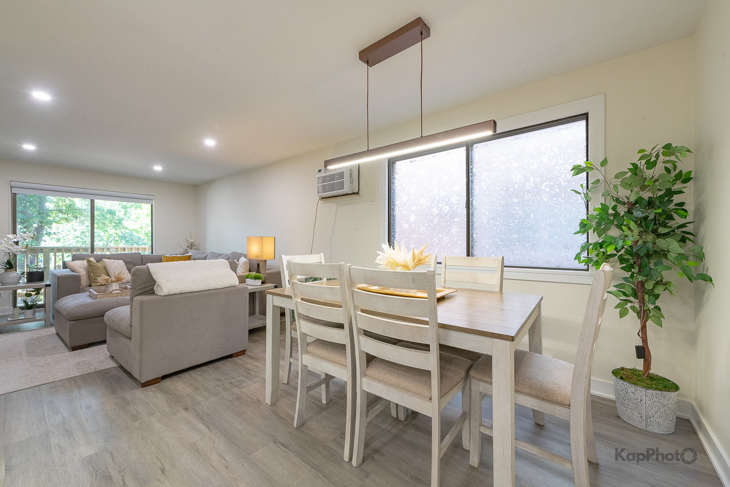 6612 West 64th Place, Unit 2W Chicago, IL 60638 - Photo 7 of 28 a living room with furniture a large window and a wooden floor