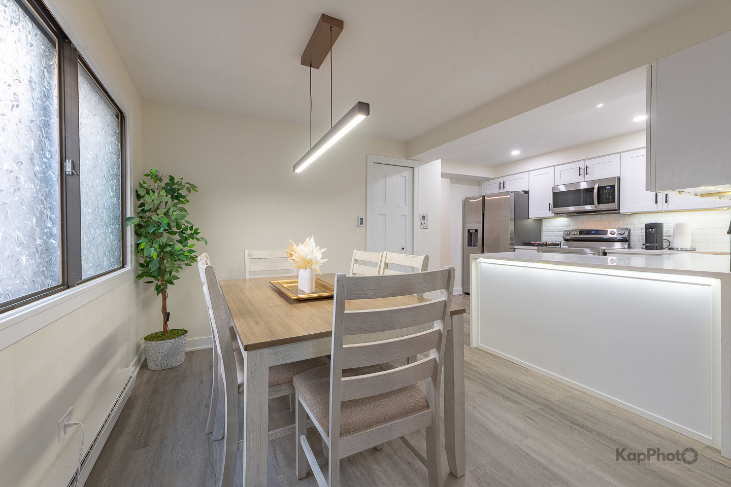 6612 West 64th Place, Unit 2W Chicago, IL 60638 - Photo 9 of 28 a kitchen with kitchen island a table and chairs in it