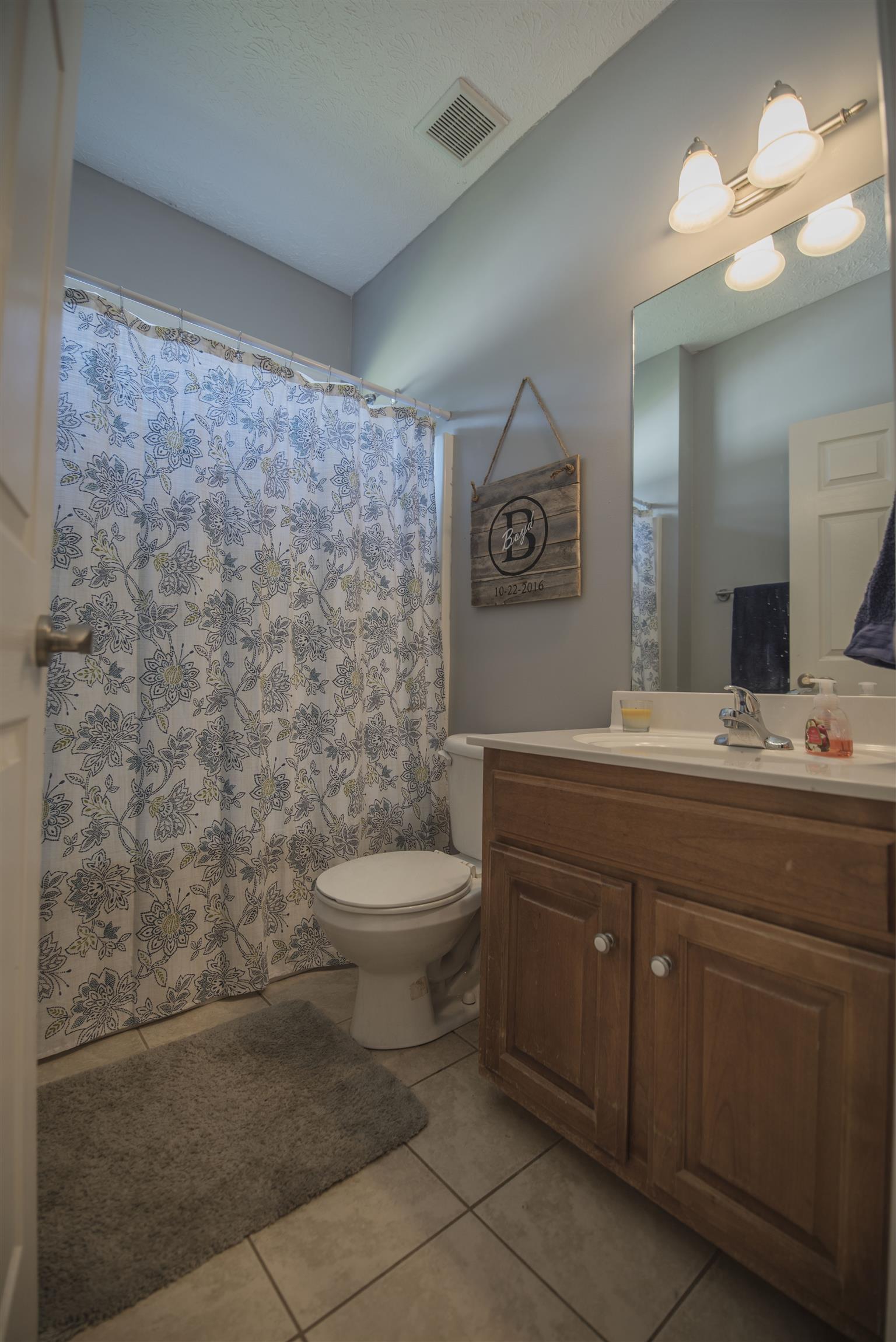 14904 Mt Pleasant Road Rockvale, TN 37153 - Photo 14 of 23 a bathroom with a toilet sink and mirror