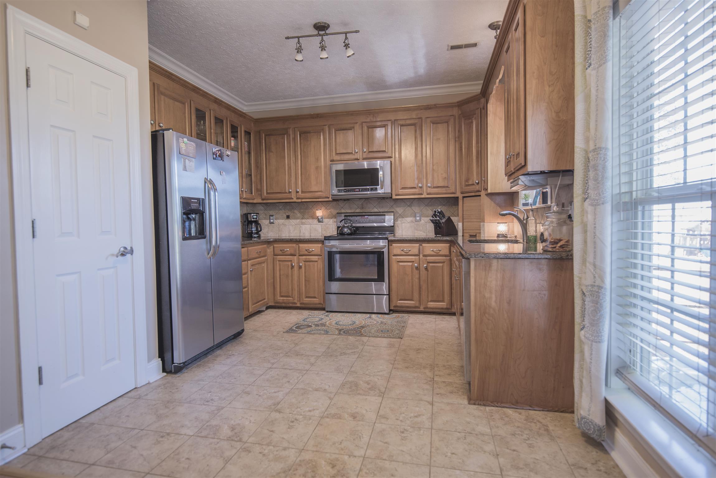 14904 Mt Pleasant Road Rockvale, TN 37153 - Photo 7 of 23 a kitchen with stainless steel appliances granite countertop a refrigerator oven a sink and dishwasher