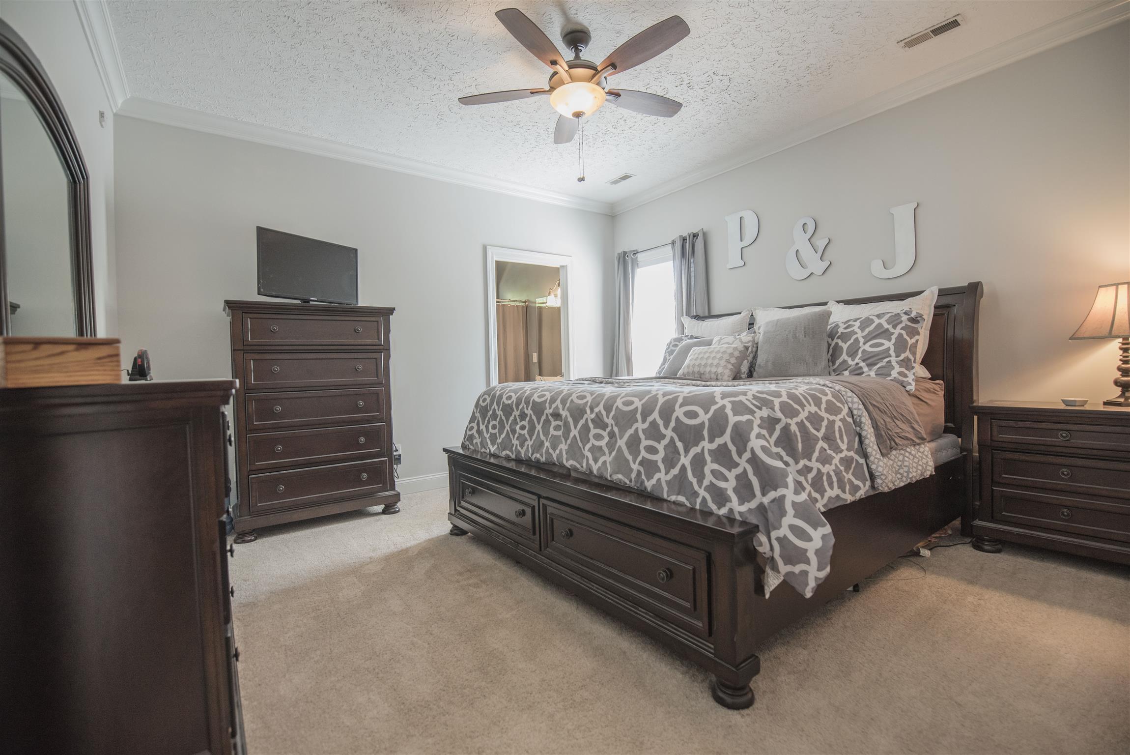 14904 Mt Pleasant Road Rockvale, TN 37153 - Photo 9 of 23 a bedroom with a bed and a chandelier