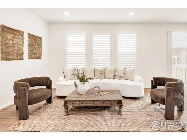 a living room with furniture rug and window