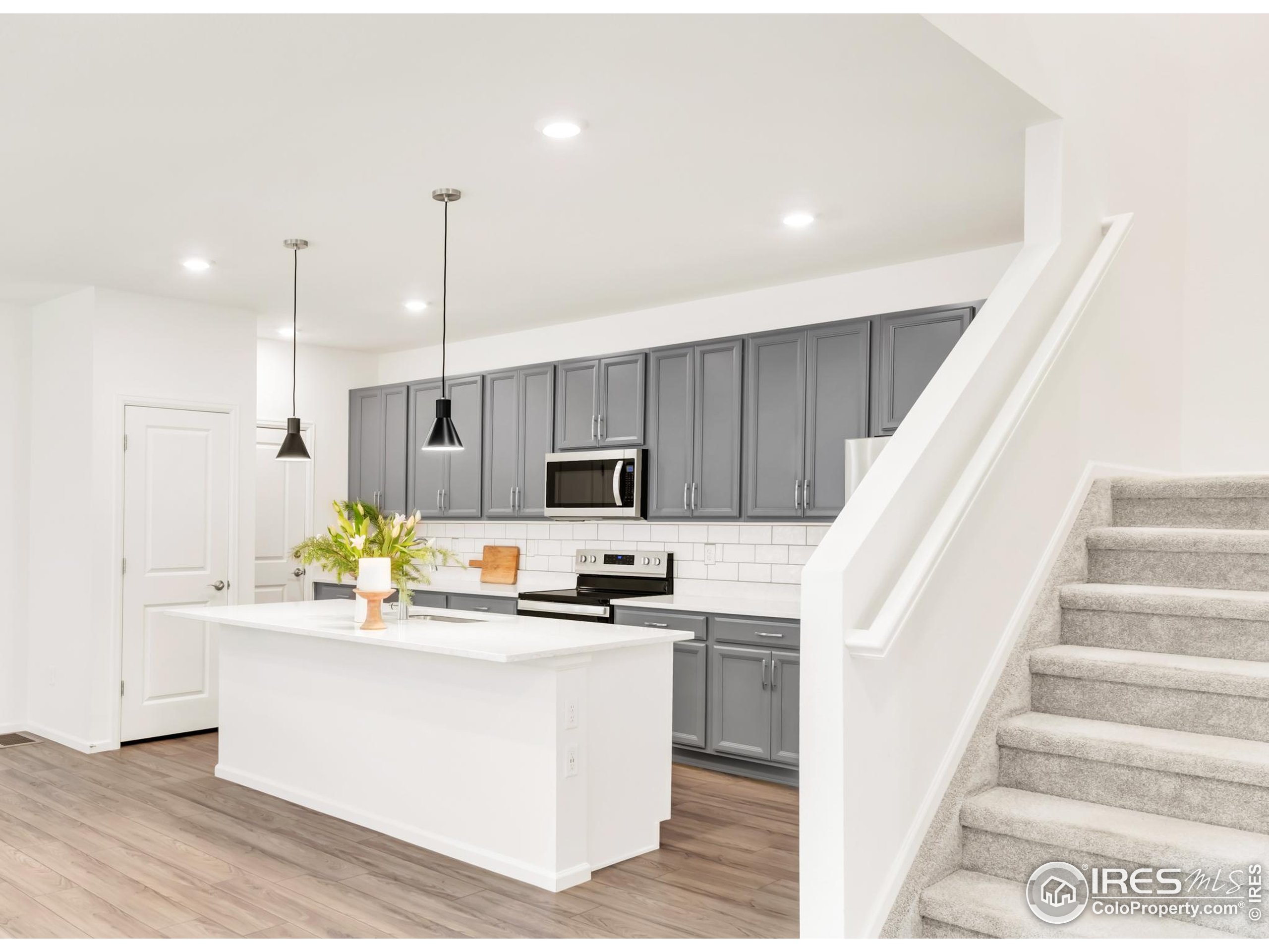 2455 Alpine Street Longmont, CO 80504 - Photo 13 of 30 a kitchen with kitchen island stainless steel appliances a sink and counter space