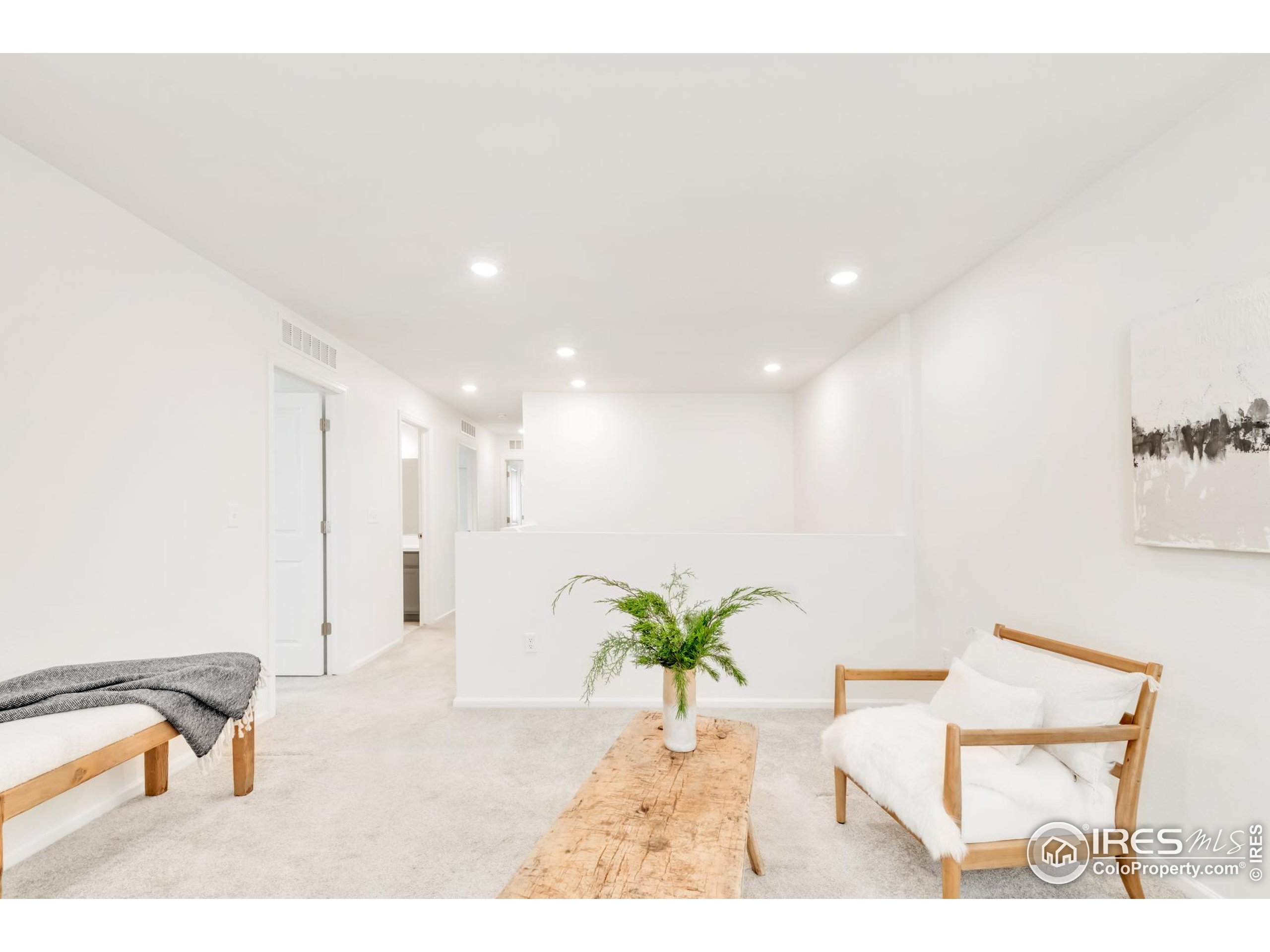 2455 Alpine Street Longmont, CO 80504 - Photo 15 of 30 a view of a hallway with furniture and a potted plant