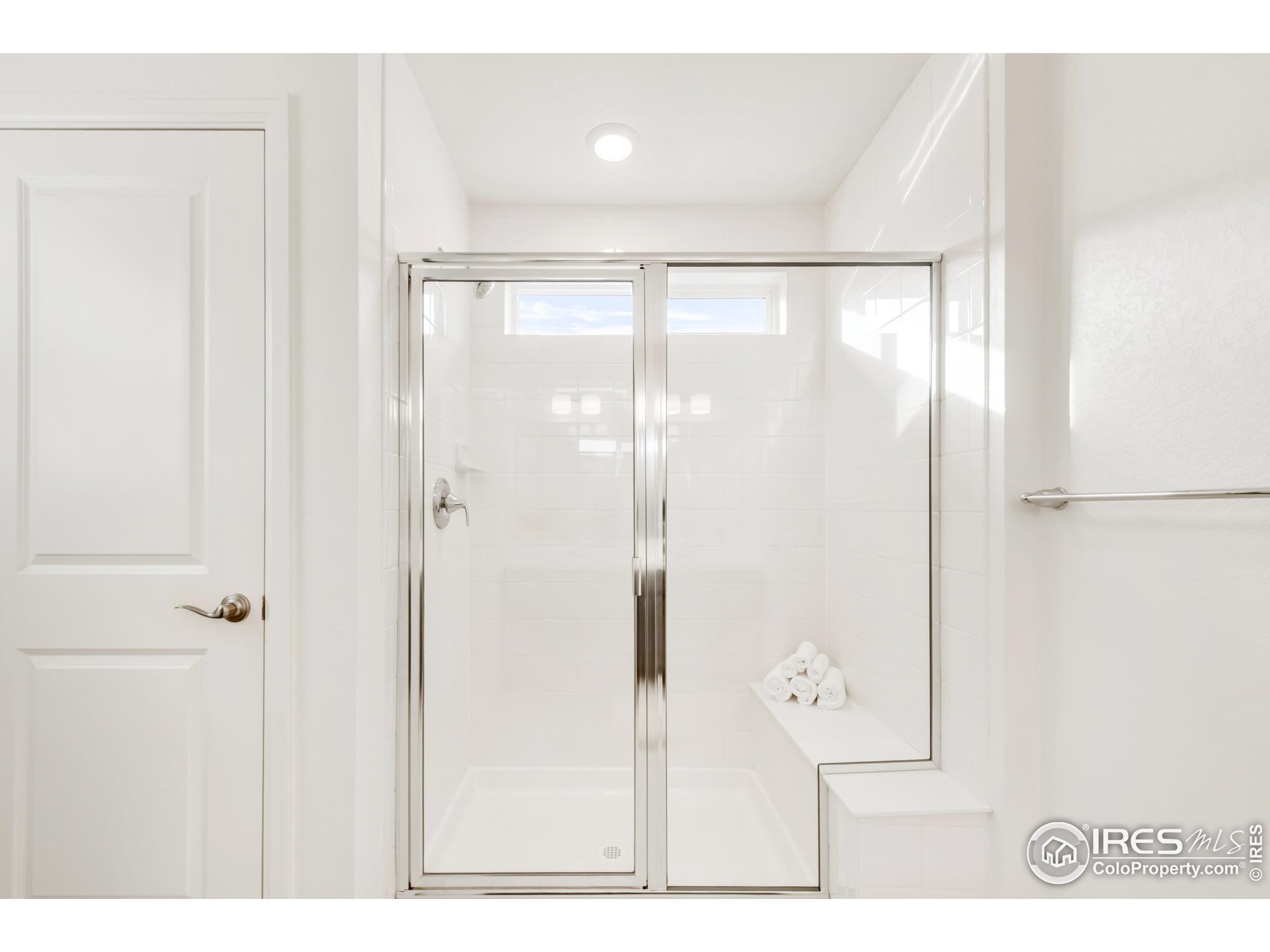 2455 Alpine Street Longmont, CO 80504 - Photo 21 of 30 a bathroom with a glass shower door