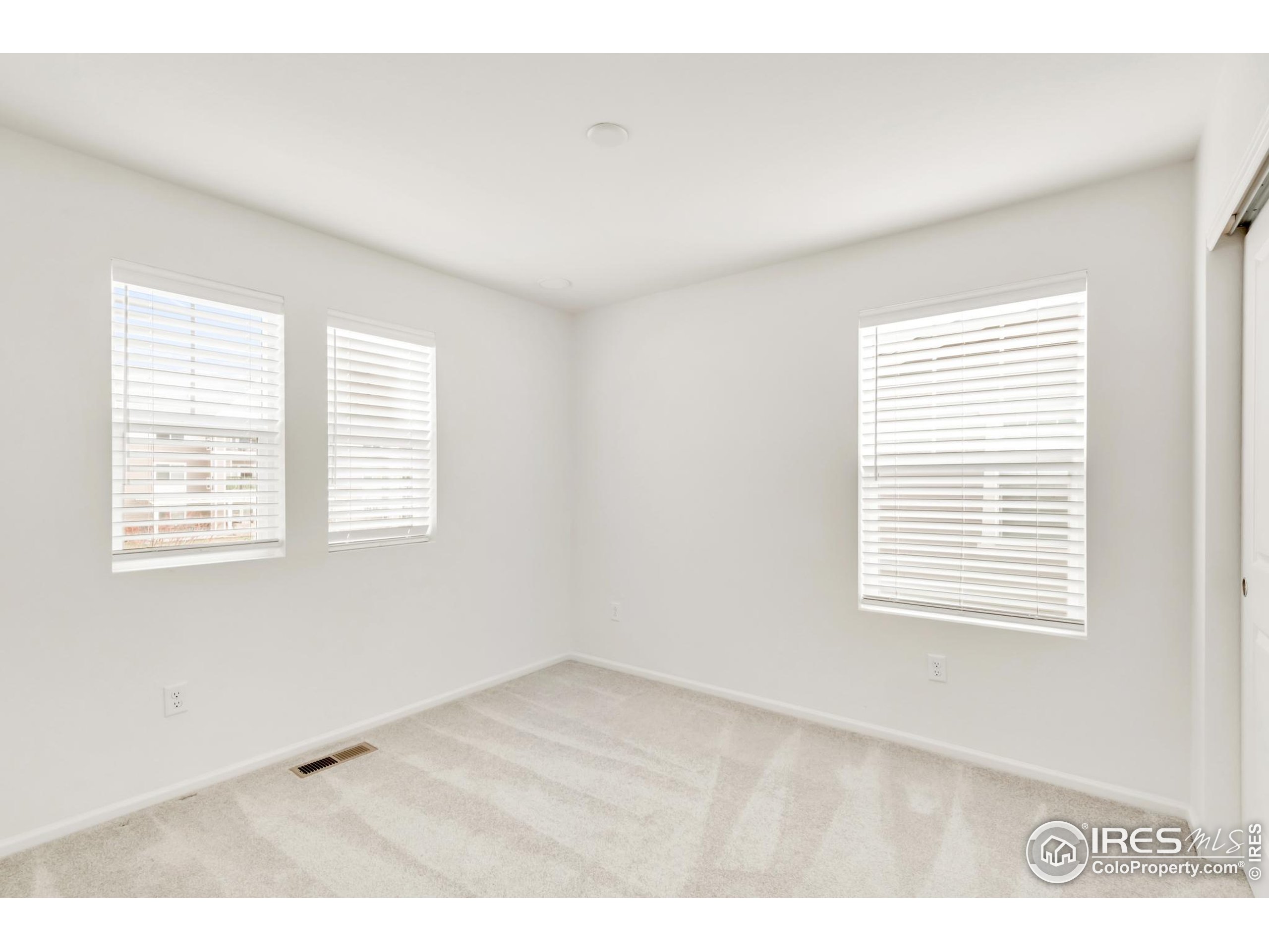 2455 Alpine Street Longmont, CO 80504 - Photo 22 of 30 a view of an empty room with a window