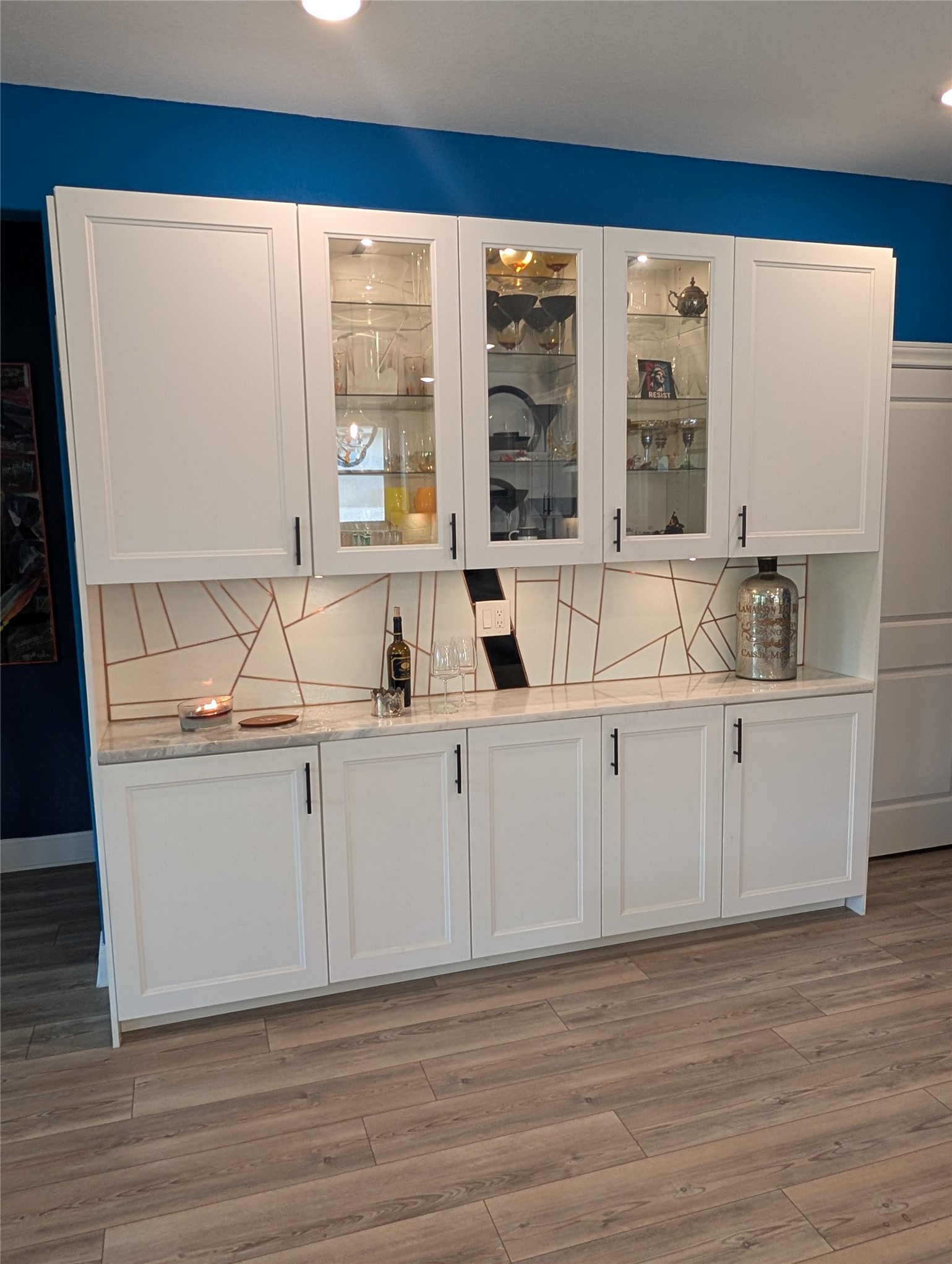 336 Kitty Hawk Road Georgetown, TX 78633 - Photo 13 of 40 Custom built-in cabinetry provides ample storage and display space over durable wood-look flooring.
