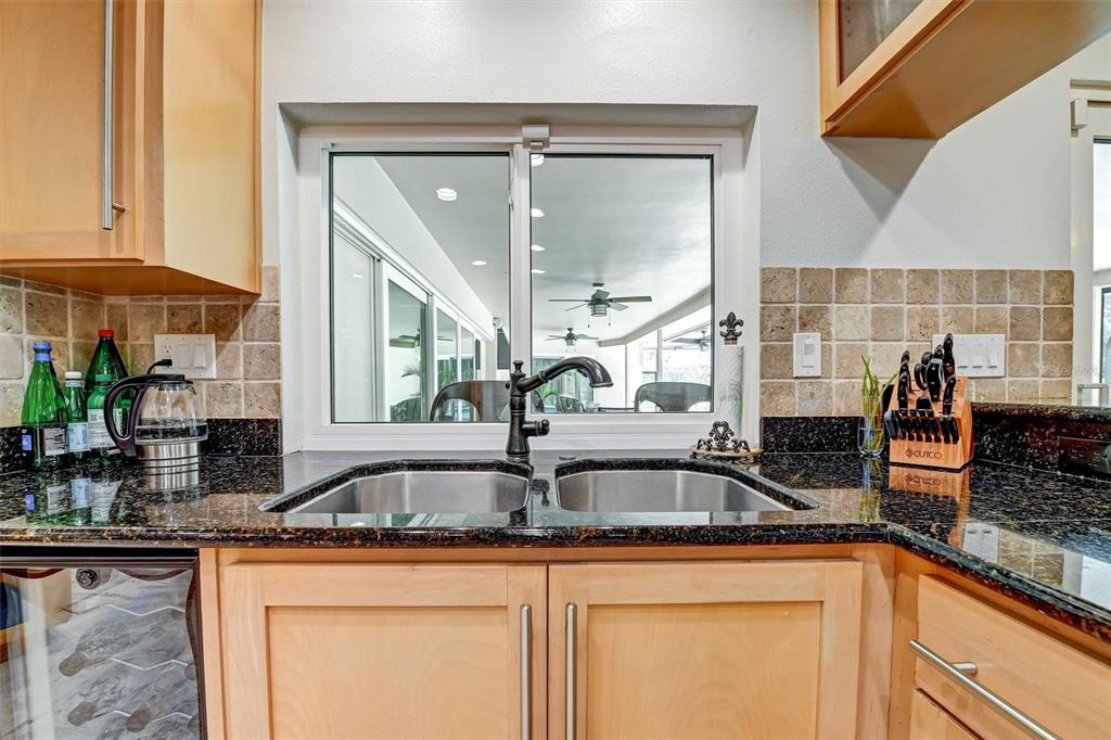1875 Belleair Road Clearwater, FL 33764 - Photo 18 of 100 a kitchen with sink a counter top space and cabinets