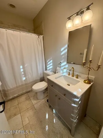 a white toilet sitting next to a shower curtain