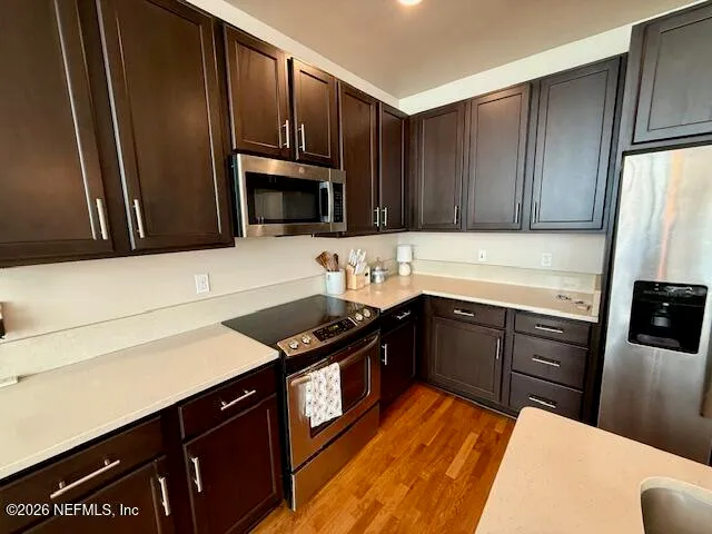 a kitchen with metallic refrigerator and cabinets