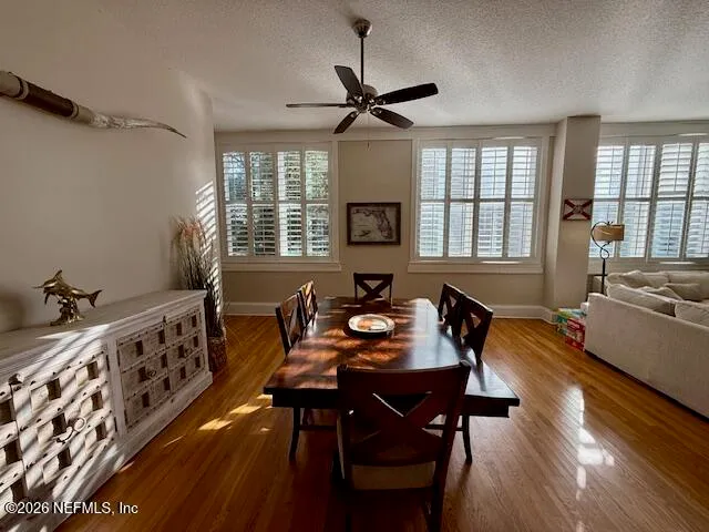a living room with furniture a flat screen tv and a large window