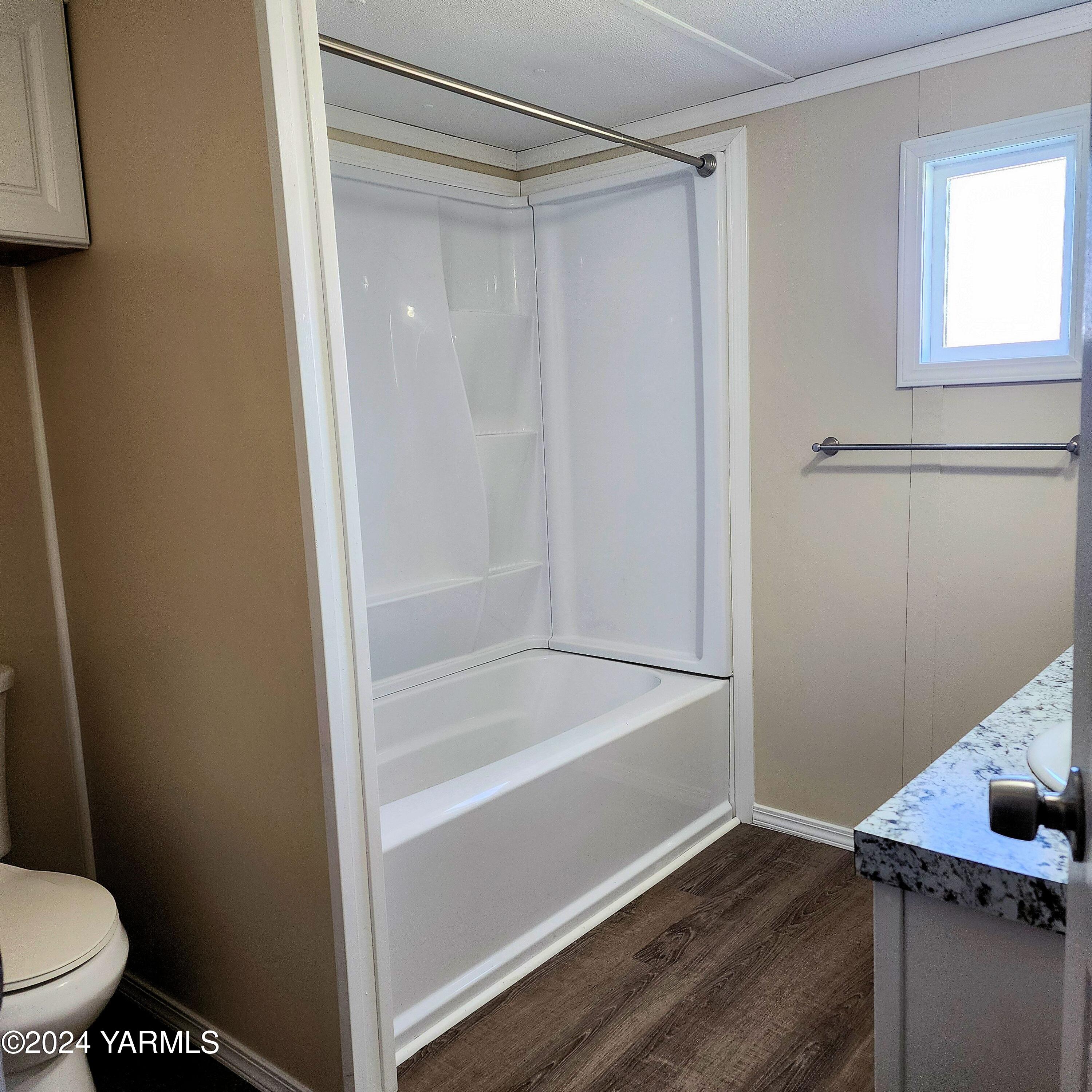 181 Schut Road, Unit 34 Moxee, WA 98936 - Photo 16 of 18 a bathroom with a shower and a toilet