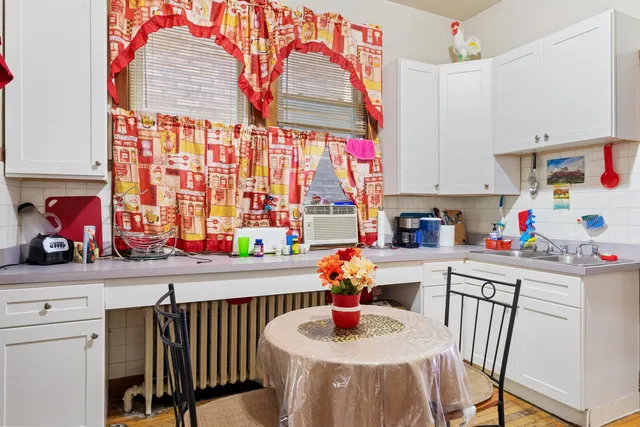 a kitchen with a sink a window and cabinets