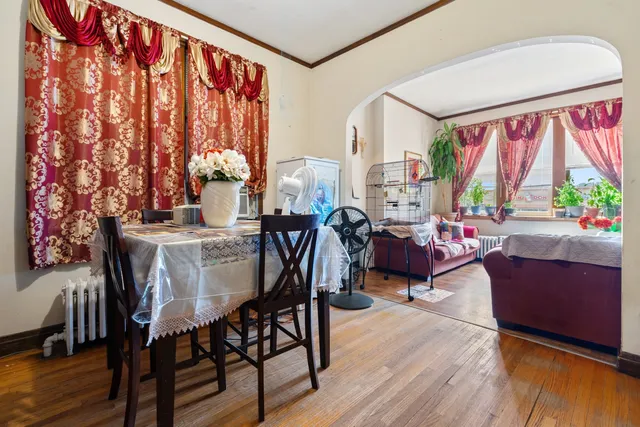 a view of a room with wooden floor and windows