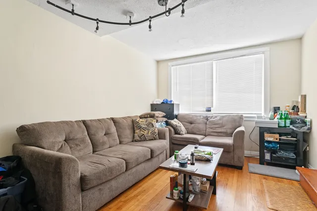 a view of a room with wooden floor and windows