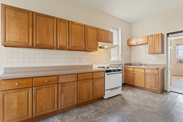 a kitchen with granite countertop white cabinets stainless steel appliances and sink