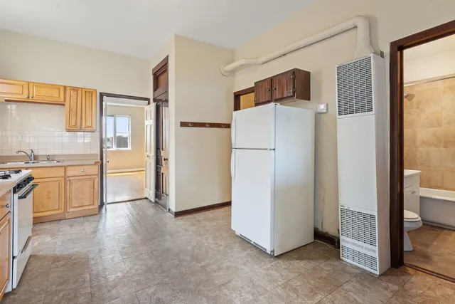 a view of a kitchen with a refrigerator and a stove