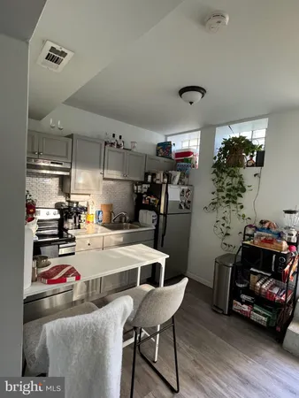 a kitchen with sink refrigerator and stove