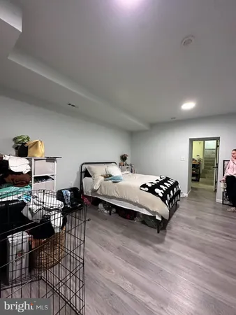 a bedroom with furniture and wooden floor