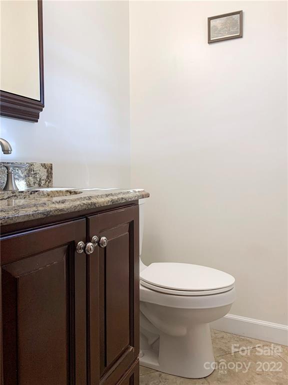 118 Patrick Road Gastonia, NC 28056 - Photo 17 of 45 a bathroom with a granite countertop toilet and a sink