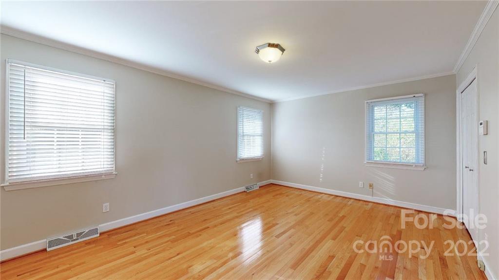 118 Patrick Road Gastonia, NC 28056 - Photo 22 of 45 a view of empty room with wooden floor and fan