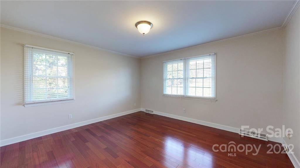 118 Patrick Road Gastonia, NC 28056 - Photo 23 of 45 an empty room with wooden floor and windows