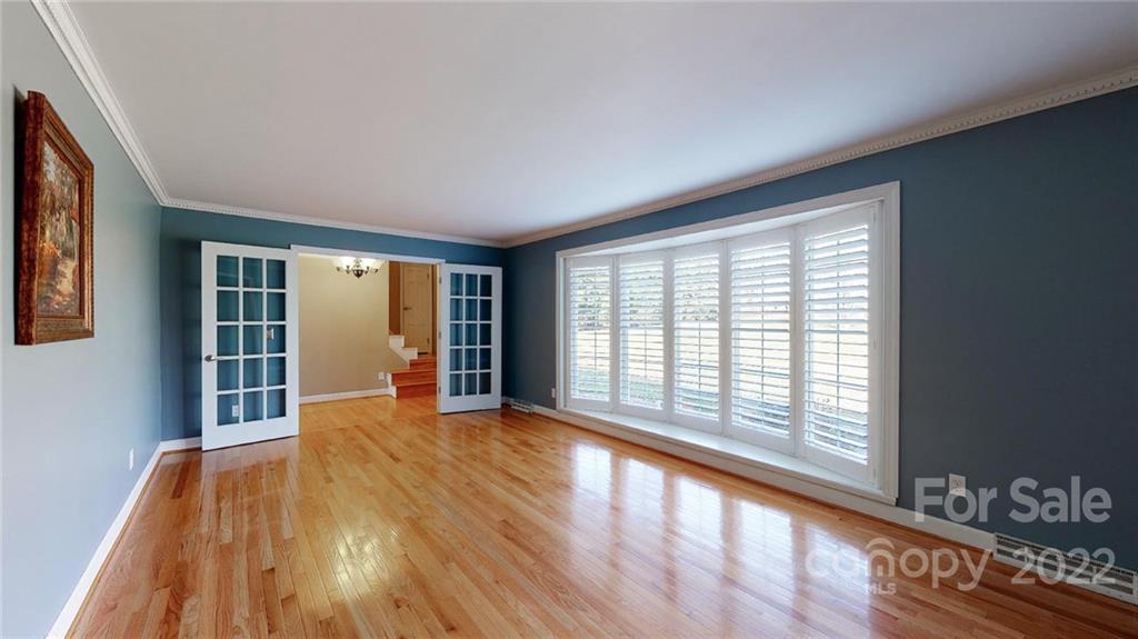 118 Patrick Road Gastonia, NC 28056 - Photo 8 of 45 a view of empty room with wooden floor and fan