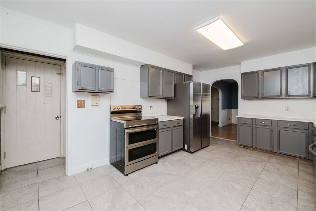 277 Valentine Street Fall River, MA 02720 - Photo 11 of 34 a kitchen with stainless steel appliances a refrigerator and a stove top oven