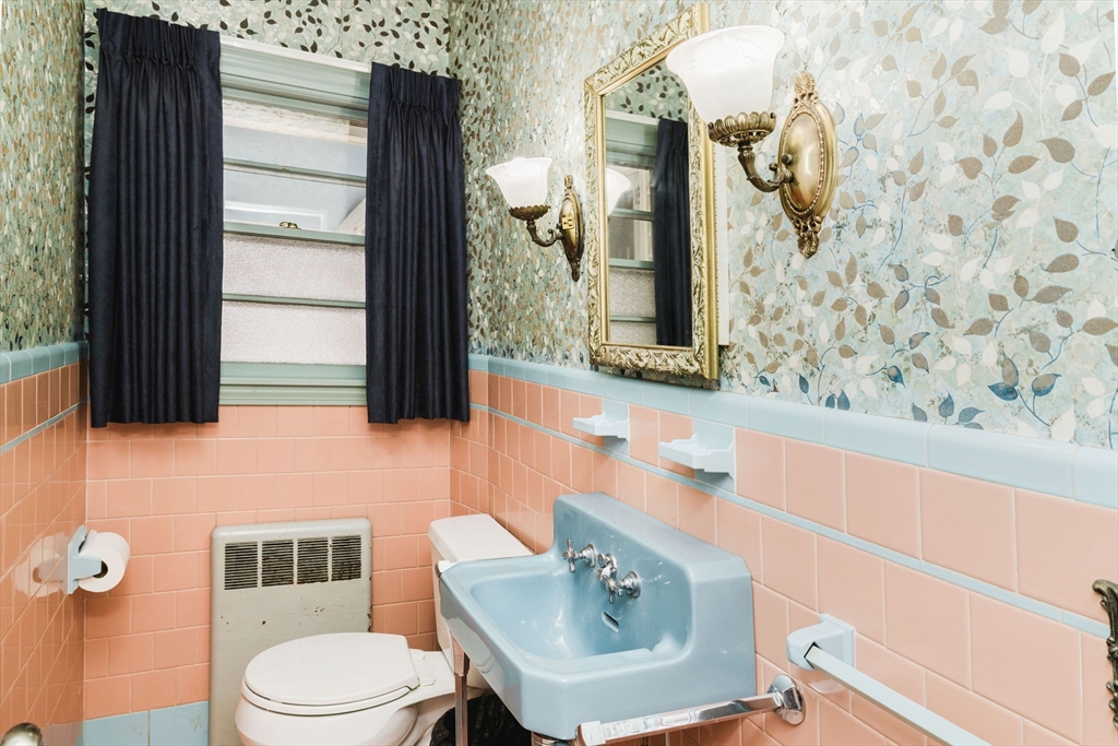 277 Valentine Street Fall River, MA 02720 - Photo 16 of 34 a bathroom with a sink a toilet and mirror