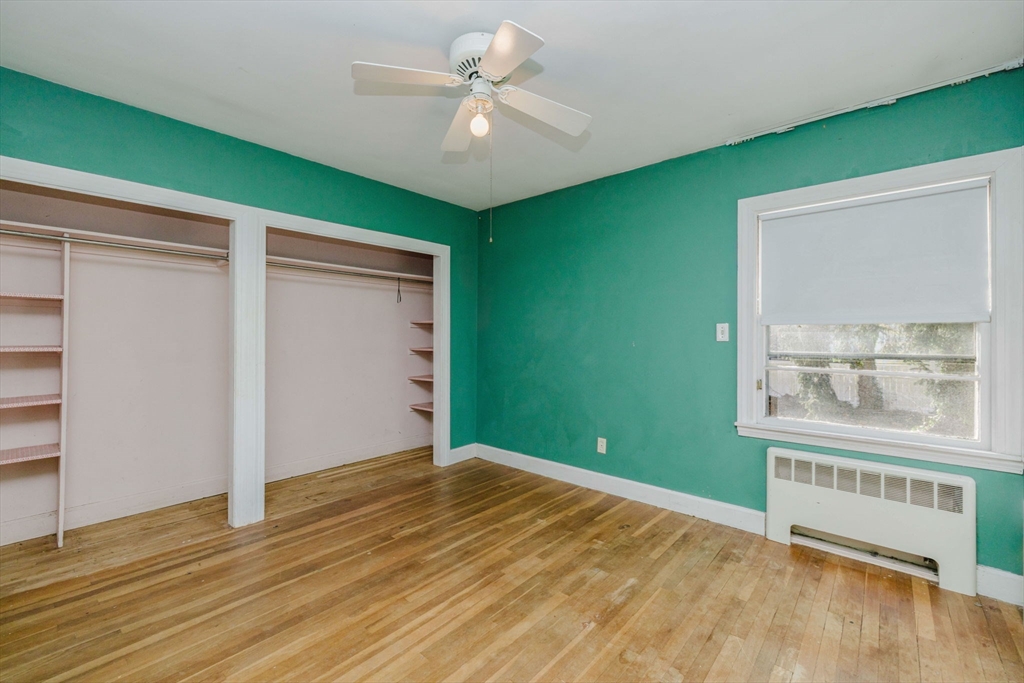 277 Valentine Street Fall River, MA 02720 - Photo 22 of 34 an empty room with wooden floor fan and windows