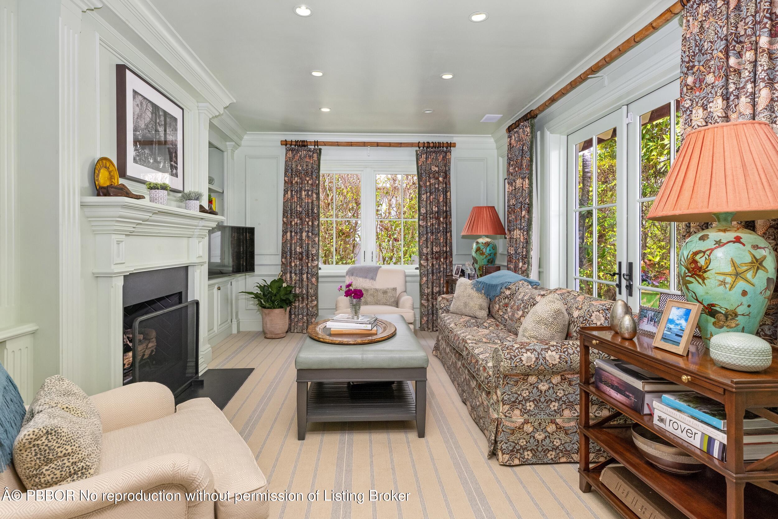 258 List Road Palm Beach, FL 33480 - Photo 21 of 45 a living room with furniture a fireplace and a floor to ceiling window