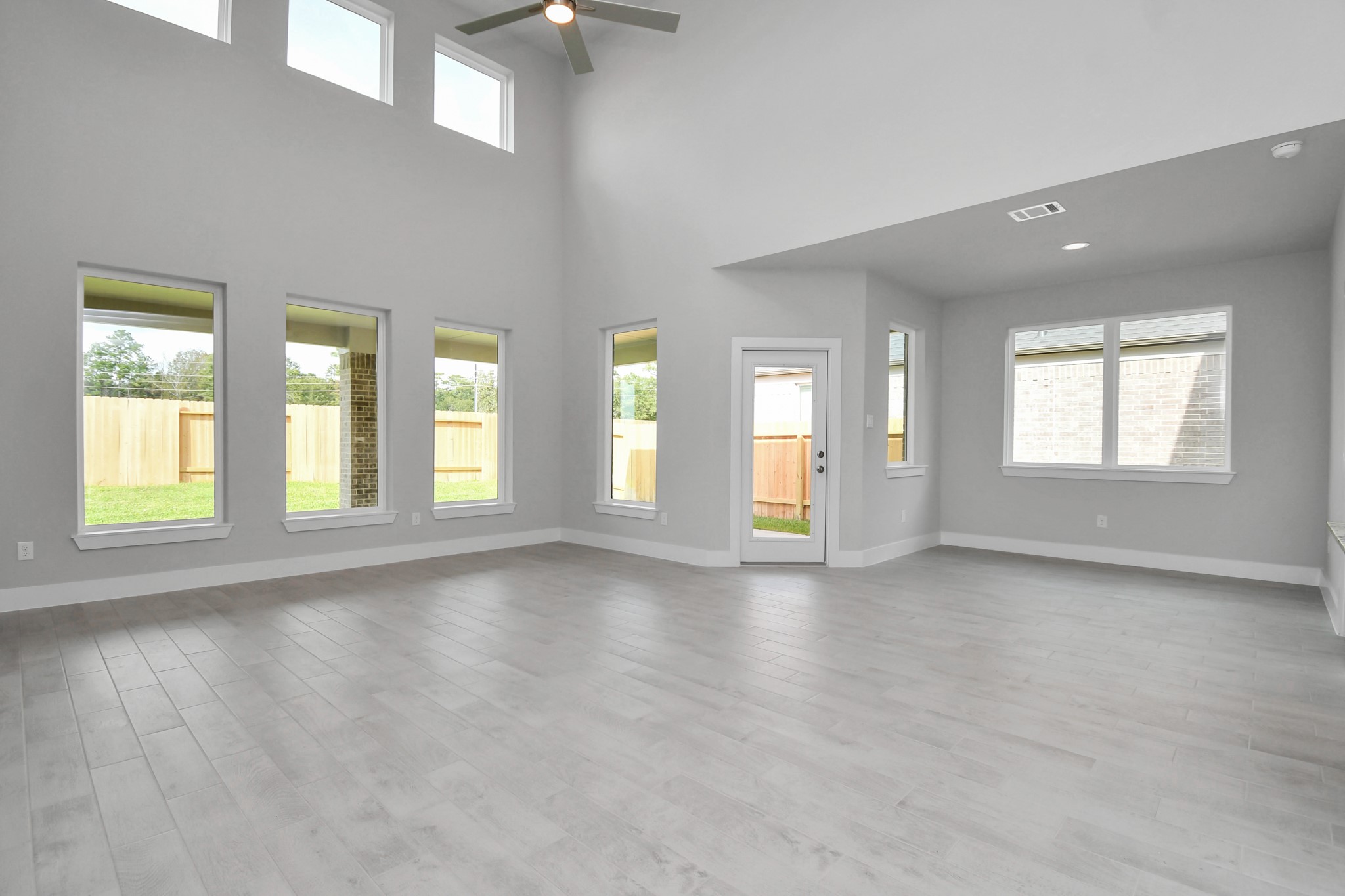 3043 Native Spg Drive Spring, TX 77373 - Photo 20 of 39 Gather the family and guests together in your lovely living room! Featuring soaring high ceilings, recessed lighting, ceiling fan, custom paint, gorgeous floors, and large windows that provide plenty of natural lighting throughout the day. Sample photo of completed home with similar floor plan. Actual colors and selections may vary.