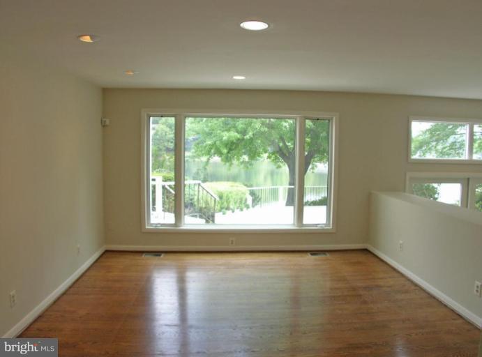 2204 Spinnaker Court Reston, VA 20191 - Photo 2 of 20 an empty room with wooden floor and windows