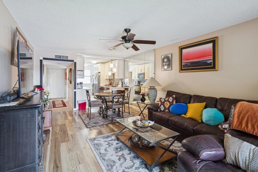 9670 West McNab Road, Unit 208 Tamarac, FL 33321 - Photo 17 of 22 a living room with furniture and wooden floor