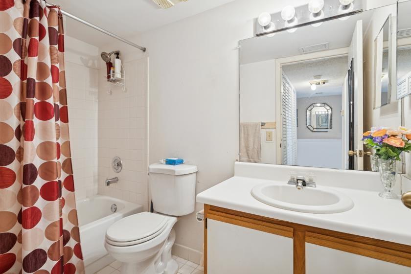 9670 West McNab Road, Unit 208 Tamarac, FL 33321 - Photo 18 of 22 a bathroom with a sink and a mirror