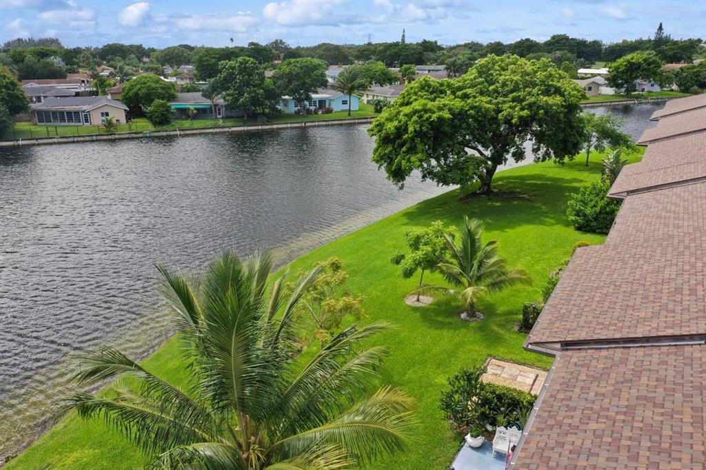 9670 West McNab Road, Unit 208 Tamarac, FL 33321 - Photo 2 of 22 a view of a lake with a yard
