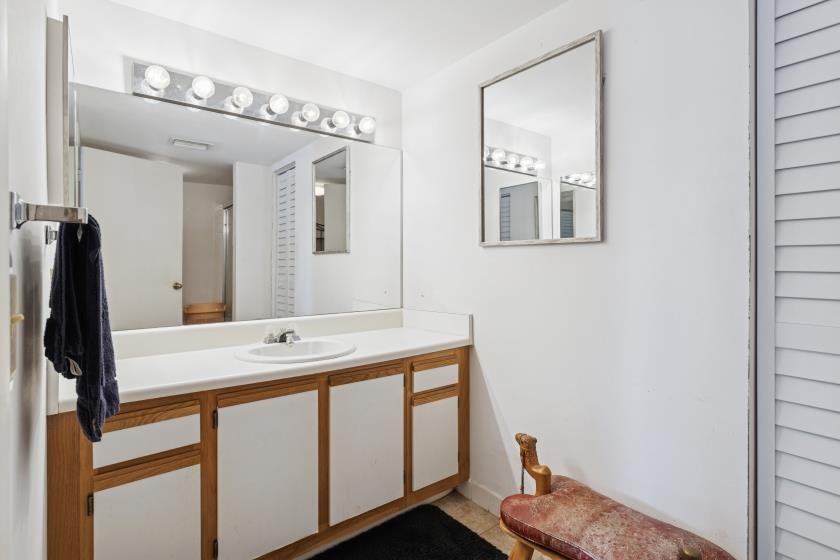 9670 West McNab Road, Unit 208 Tamarac, FL 33321 - Photo 21 of 22 a bathroom with a sink vanity and mirror